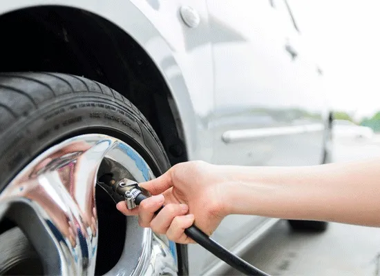 a person inflating a tire - will boost fuel mileage
